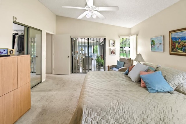 bedroom with lofted ceiling, ceiling fan, a textured ceiling, light carpet, and a closet