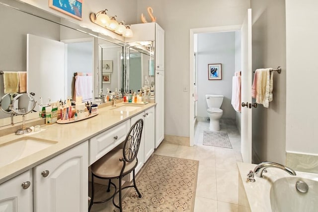 bathroom with vanity, tile patterned floors, a tub, and toilet