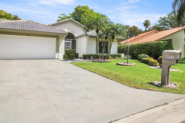 mediterranean / spanish-style home featuring a garage and a front yard