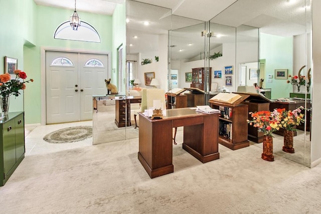 carpeted entryway featuring a high ceiling