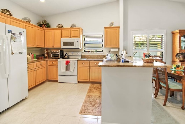 kitchen featuring light tile patterned flooring, lofted ceiling, sink, kitchen peninsula, and white appliances