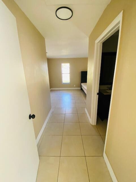 hall featuring light tile patterned floors