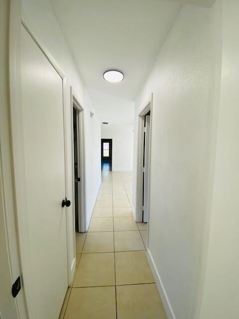 hall featuring light tile patterned floors