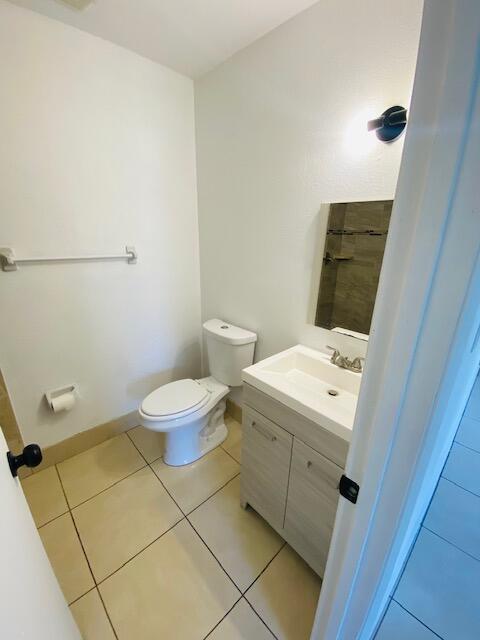 bathroom featuring tile patterned floors, toilet, and vanity