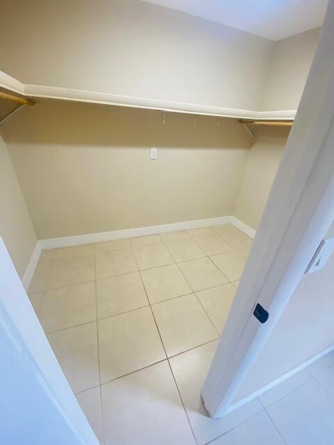 walk in closet featuring tile patterned flooring