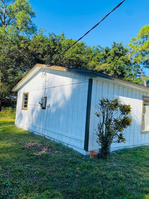 view of outbuilding featuring a yard