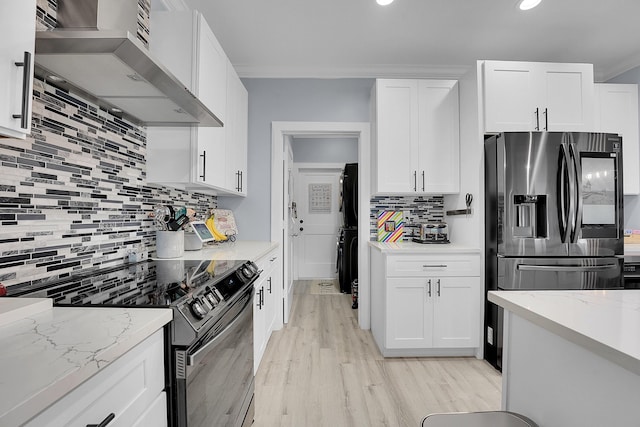 kitchen with white cabinetry, light stone counters, black electric range, and wall chimney exhaust hood