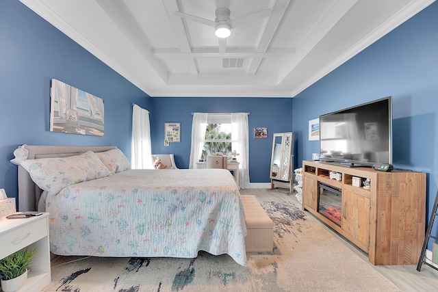 bedroom featuring coffered ceiling, beam ceiling, ornamental molding, and ceiling fan