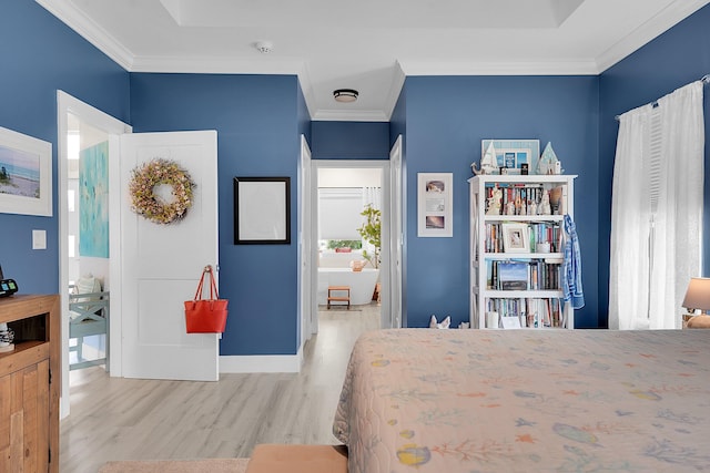 bedroom with crown molding and light hardwood / wood-style flooring