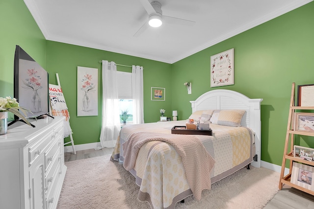 bedroom with crown molding, ceiling fan, and light hardwood / wood-style floors