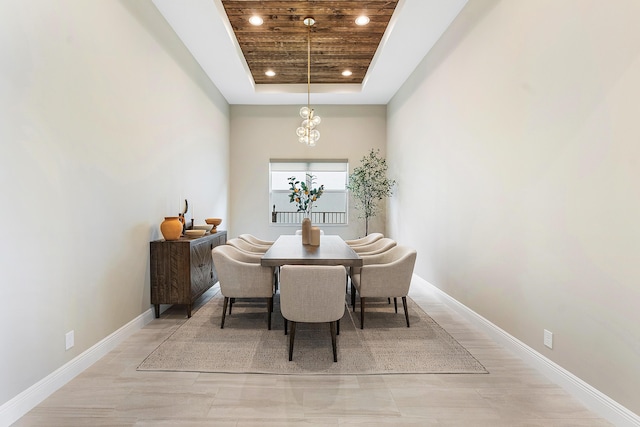 dining room featuring wooden ceiling and a tray ceiling