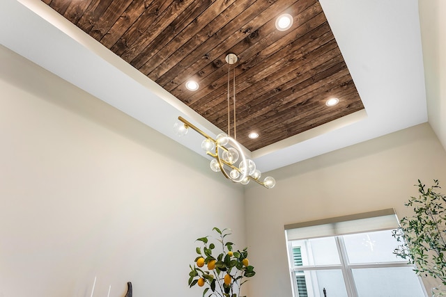 room details featuring a raised ceiling and wooden ceiling