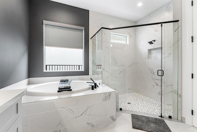 bathroom featuring plus walk in shower and vanity