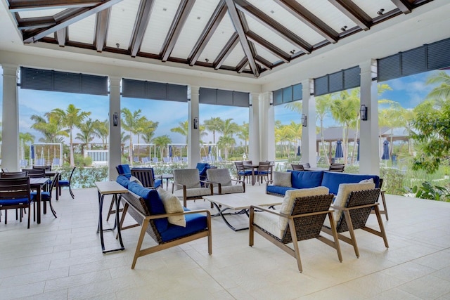 sunroom with vaulted ceiling with beams