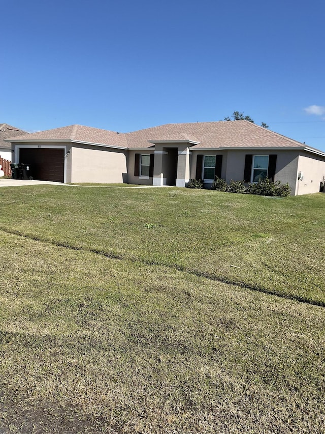 single story home featuring a garage and a front yard