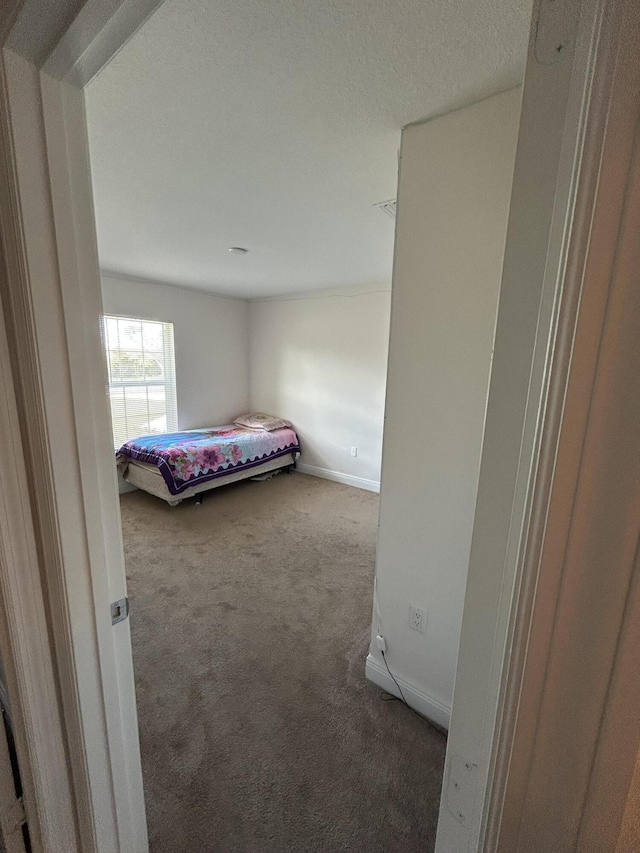 unfurnished bedroom with dark carpet