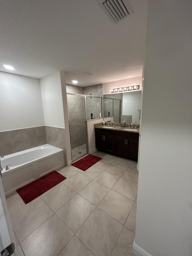 bathroom featuring vanity, plus walk in shower, and tile patterned flooring