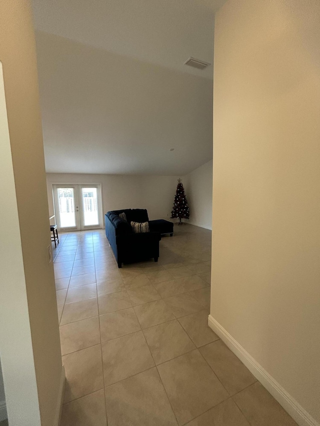 hall with light tile patterned floors