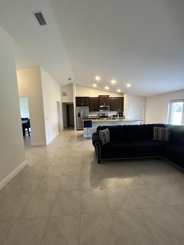 tiled living room with lofted ceiling