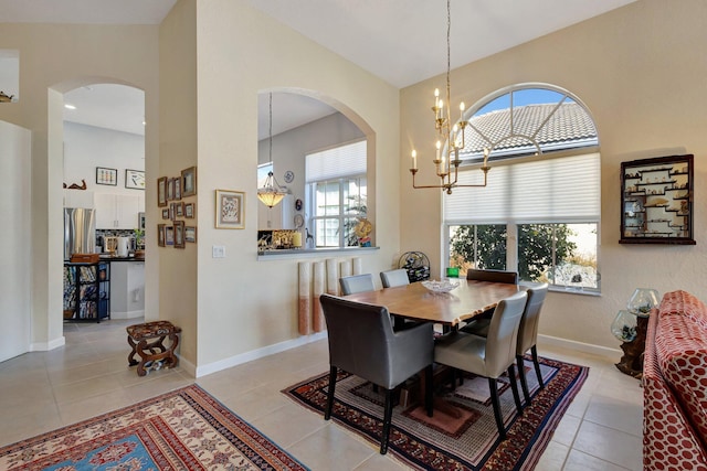 tiled dining area featuring an inviting chandelier