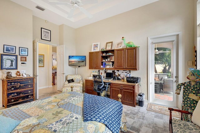 bedroom with multiple windows, built in desk, access to outside, and ceiling fan