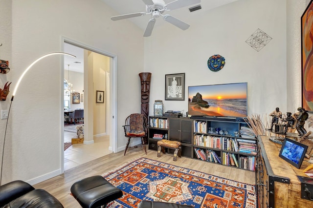 living area featuring ceiling fan and light hardwood / wood-style flooring