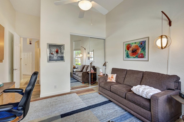 office area with hardwood / wood-style floors, high vaulted ceiling, and ceiling fan