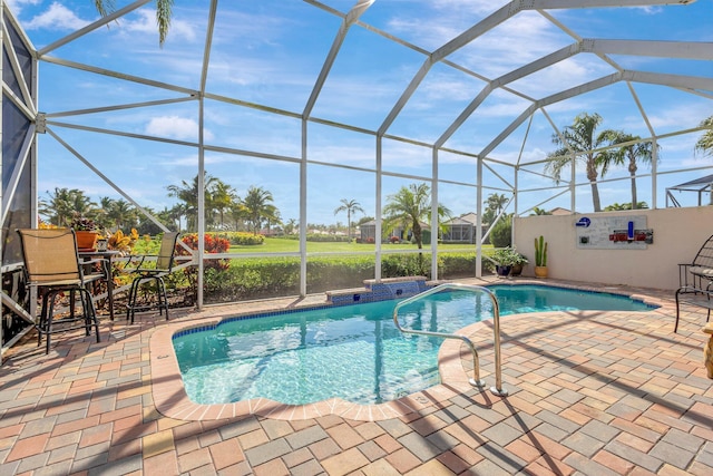 view of swimming pool with a lanai and a patio area