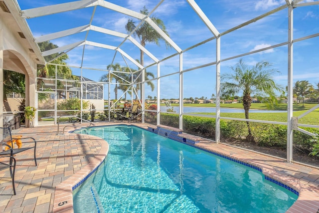 view of swimming pool featuring a water view, glass enclosure, and a patio area