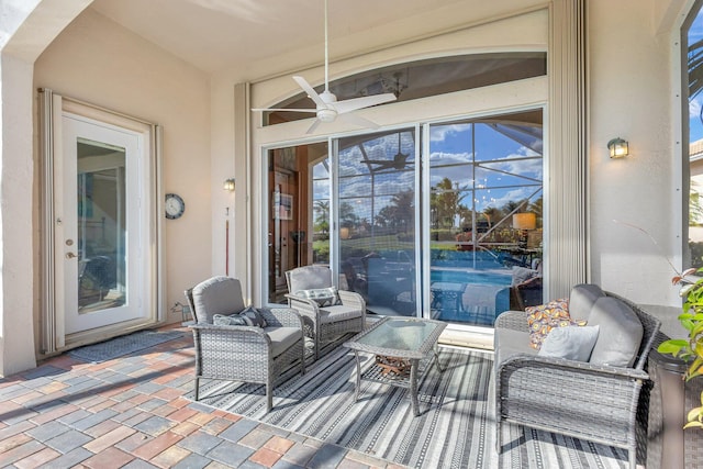 view of patio with ceiling fan and a lanai