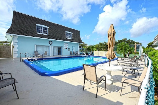 view of swimming pool featuring a patio area