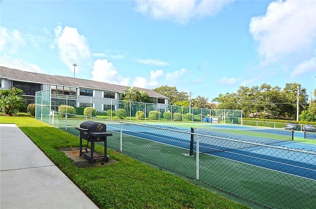 view of sport court featuring a yard