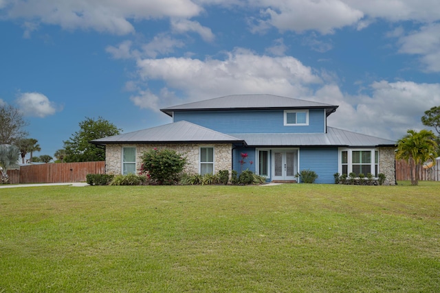 view of front of property with french doors and a front lawn