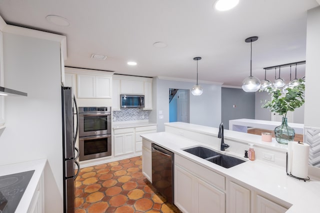 kitchen featuring decorative light fixtures, tasteful backsplash, white cabinetry, sink, and black appliances