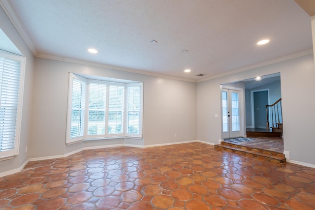 empty room with ornamental molding and french doors