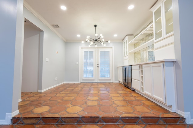 kitchen featuring decorative light fixtures, white cabinets, a chandelier, ornamental molding, and french doors