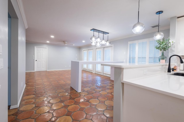 kitchen featuring crown molding, ceiling fan, sink, and hanging light fixtures