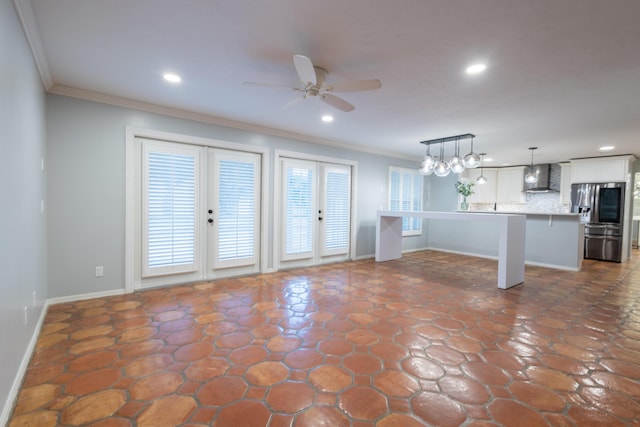 unfurnished living room featuring ornamental molding and ceiling fan