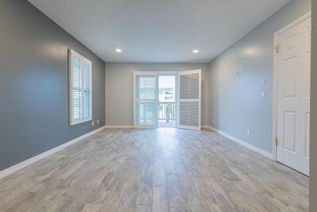 unfurnished room featuring light hardwood / wood-style floors