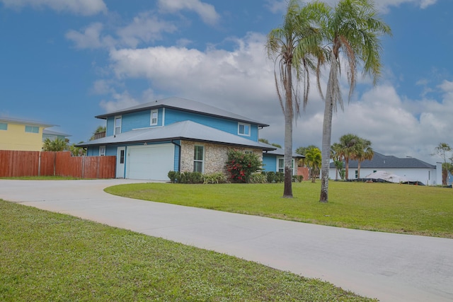 view of front facade featuring a garage and a front lawn