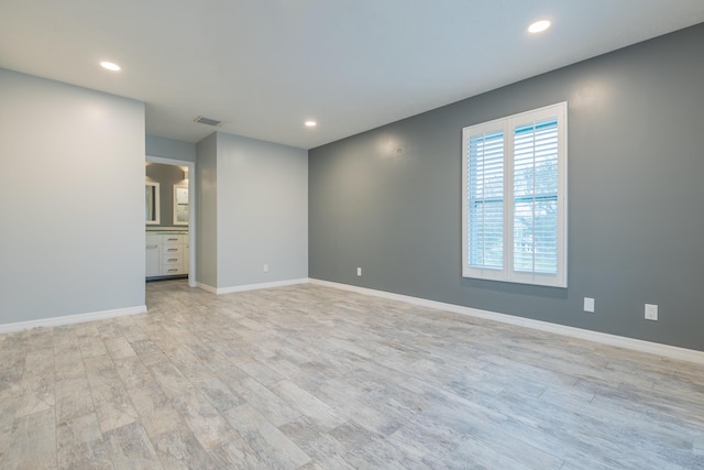 spare room with light hardwood / wood-style floors