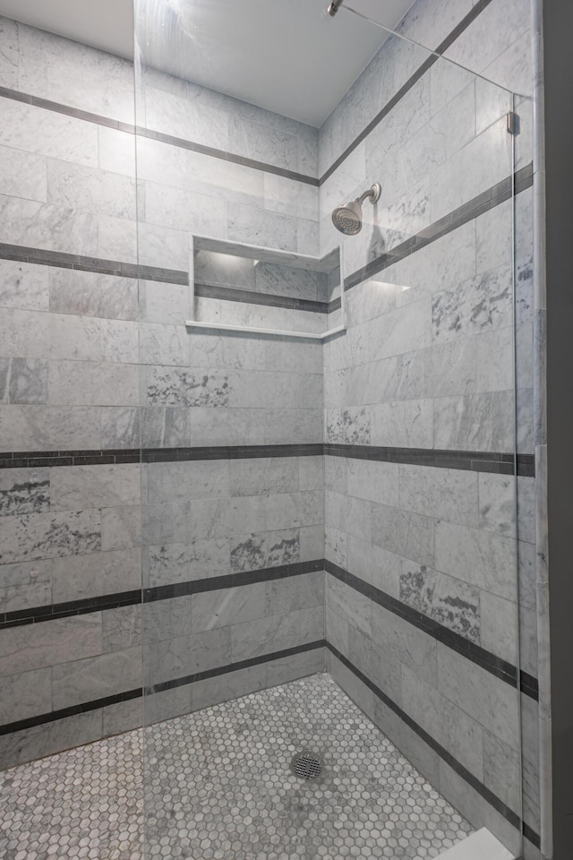 bathroom with tiled shower