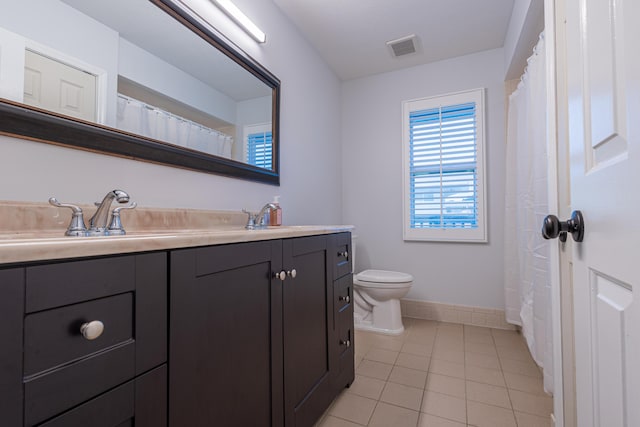 bathroom featuring vanity, tile patterned floors, and toilet