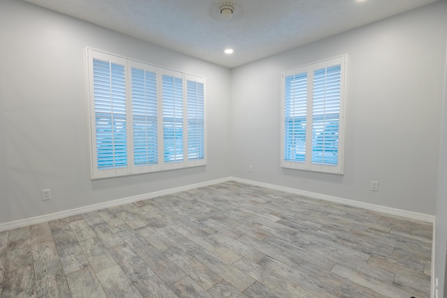 spare room featuring light hardwood / wood-style floors