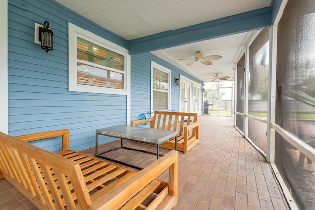 sunroom featuring ceiling fan