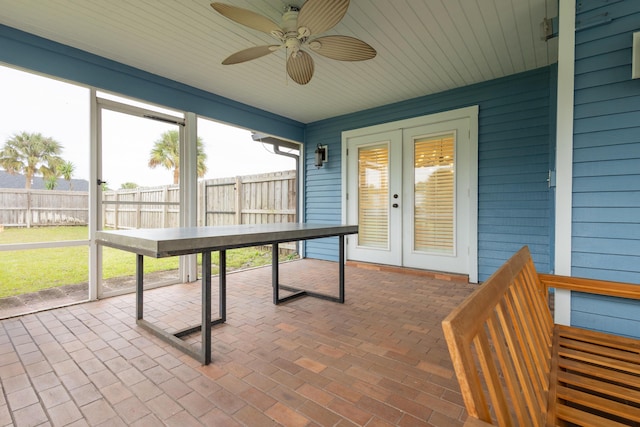 unfurnished sunroom with french doors and ceiling fan