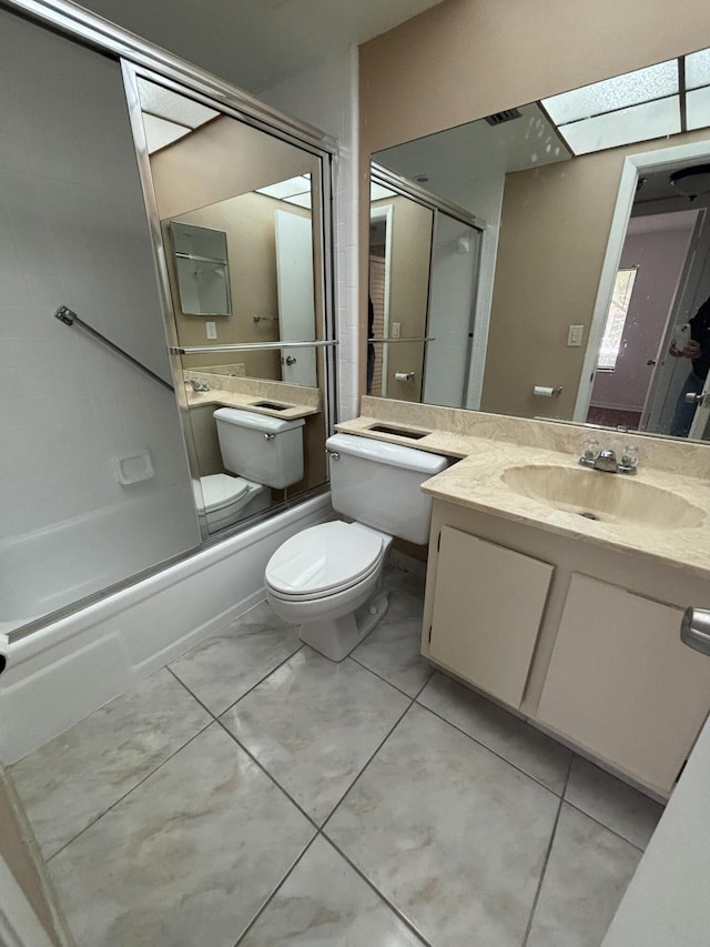 bathroom featuring combined bath / shower with glass door, vanity, and toilet