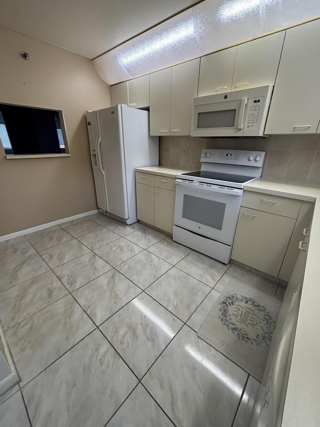 kitchen with tasteful backsplash and white appliances