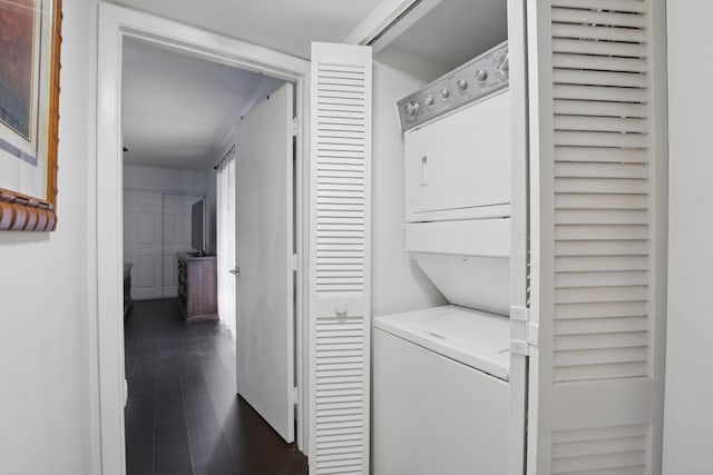 clothes washing area with stacked washer / dryer and dark hardwood / wood-style floors