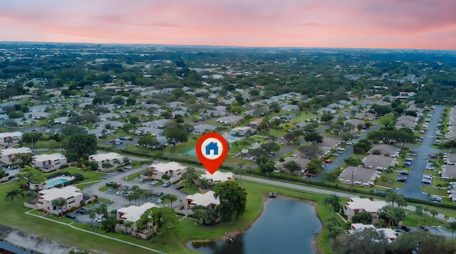 aerial view at dusk with a water view